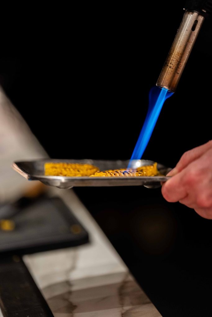 Een component wordt in de keuken van Ode afgebrand met de gasbrander